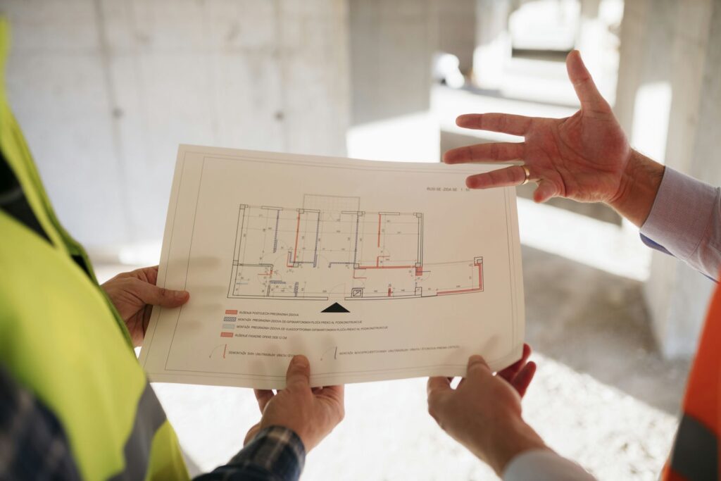 inspector and builder reviewing building code regulations