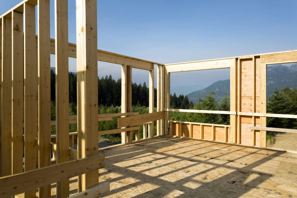 Custom home construction at multiple stages representing the big cost buckets in a $1.5M BC quote