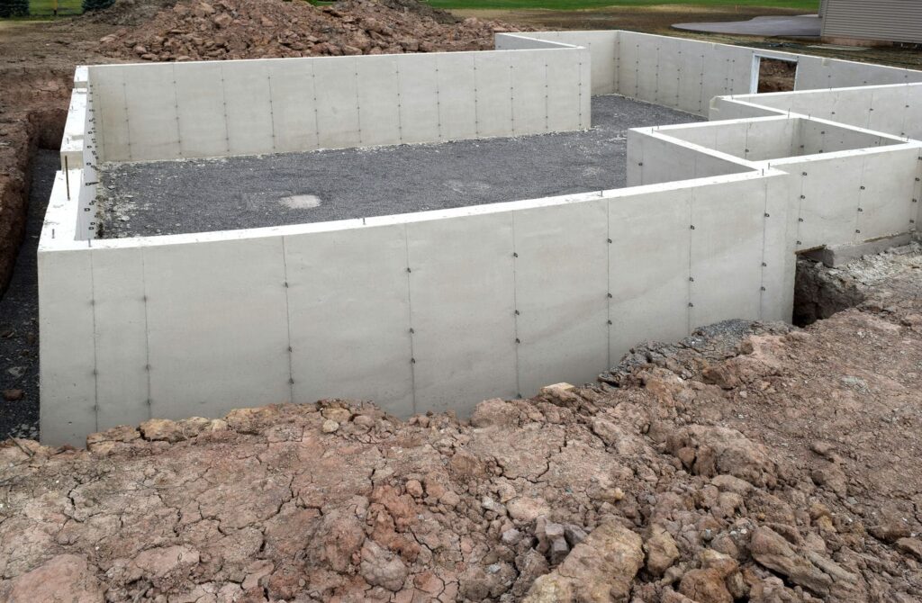 A conventional poured concrete foundation with form-tie marks, which may be enough when ICF is not justified